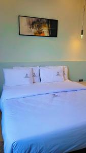 a bed in a room with a blue light on it at Grand Vachellia Karatu in Karatu