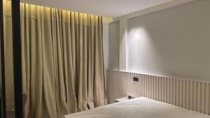 a bedroom with a bed and a curtain at Grand Vachellia Karatu in Karatu