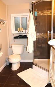 a bathroom with a toilet and a shower at Nestled Inn Bed and Breakfast in Victoria +32 photos