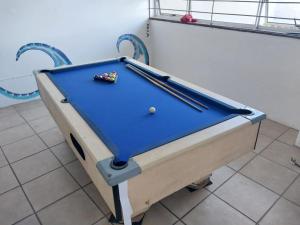a pool table with two cuesticks on top of it at Peacehaven's Top Floor Gem 703 in Scottburgh +24 photos