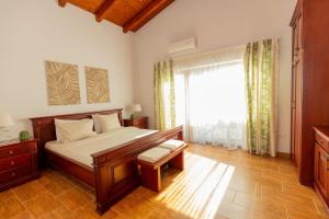 a bedroom with a bed and a large window at BELAIR Rooms Montenegro in Sutorina
