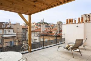 a balcony with a view of a city at Hôtel & Suites Maison Montgrand - Vieux Port in Marseille