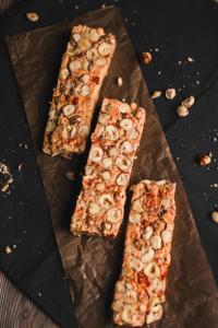 three slices of food on a cutting board with nuts at WooLiv in Coimbatore
