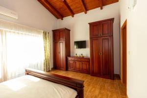 a bedroom with a bed and a wooden cabinet at BELAIR Rooms Montenegro in Sutorina