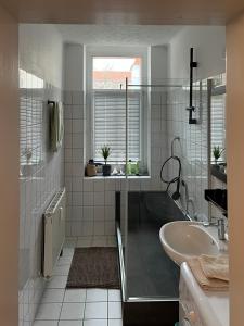 a bathroom with a tub and a sink at Hochwertige Wohnung im EG- Meißen zum Genießen in Meißen