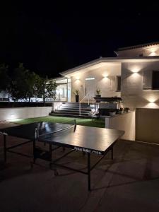 a ping pong table in front of a house at night at Villa Amelia in Capaci