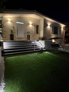 a backyard with a green lawn at night at Villa Amelia in Capaci +68 photos