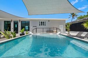 a swimming pool in the backyard of a house at La Balandra Luxury Stays in Dorado +27 photos