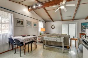 a dining room with a table and a ceiling fan at Steps to St Albans Bay! Basecamp w/ Grill in Saint Albans Bay
