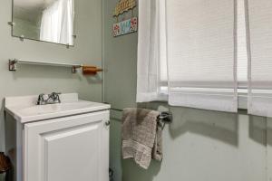 a white bathroom with a sink and a mirror at Steps to St Albans Bay! Basecamp w/ Grill in Saint Albans Bay