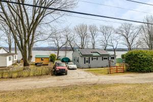 a house and two cars parked in a driveway at Steps to St Albans Bay! Basecamp w/ Grill in Saint Albans Bay