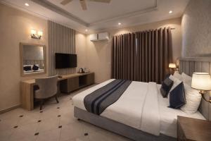 a hotel room with a bed and a desk at Shelton Rezidor House F-8 Islamabad in Islamabad