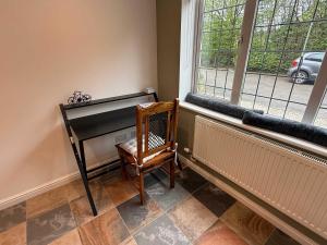 a room with a radiator and a chair next to a window at Modern Bicester Studio Self-Contained with Parking in Bicester