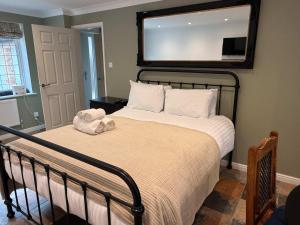 a bedroom with a bed with a mirror on the wall at Modern Bicester Studio Self-Contained with Parking in Bicester