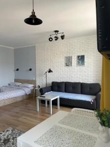 a living room with a couch and a table at Sisters apartment Val in Chernihiv