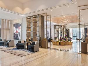 a lobby with couches and chairs in a building at 3br - PoolAccess - 7 MinstoDubai Mall - 2 KingBeds in Dubai