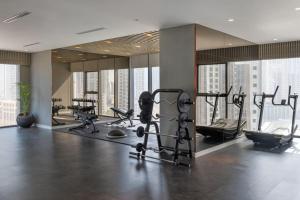 a gym with treadmills and exercise equipment in a building at 3br - PoolAccess - 7 MinstoDubai Mall - 2 KingBeds in Dubai +22 photos