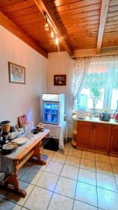 a kitchen with a table and a fish tank in a window at Luna Rooms Oświęcim in Oświęcim