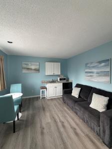 a living room with a couch and a table at Sand Pebble Motor Lodge in Point Pleasant Beach