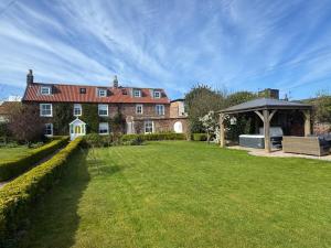 a large house with a large lawn in front of it at Bay View House in Bridlington