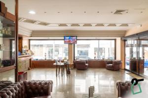 a lobby with couches and a tv in a building at Hotiday Brindisi Garibaldi in Brindisi