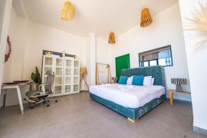 a bedroom with a bed and a desk and a chair at Loft Beachfront Bungalow with Private Beach in Dakhla