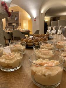 a table with many glasses of desserts on it at Yak Avenir in Aiguilles +36 photos