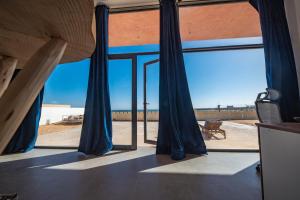 a room with a window with a view of the desert at Loft Beachfront Bungalow with Private Beach in Dakhla
