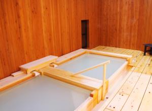 Postel nebo postele na pokoji v ubytování Onsen Yado Misuzuso