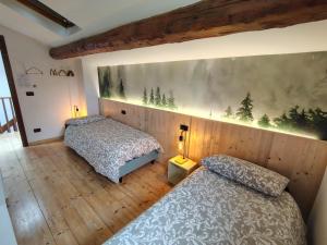 a bedroom with two beds and a painting on the wall at B&B Monte Adone in Santa Cecilia +19 photos