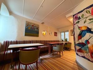 a restaurant with tables and chairs in a room at Our Hippie Castle Vianden - Unique Bohemian Guesthouse in Vianden