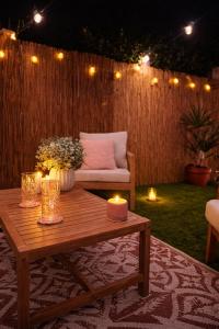 a wooden coffee table with candles and a couch at L Antre du Désir in Saint-Léonard +10 photos