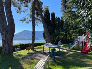 a park with a picnic table and a playground at Appartamento Pascià al Lago in Oggebio +12 photos