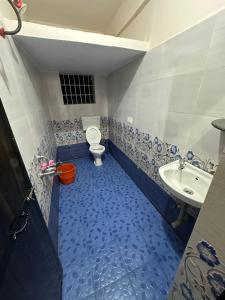 a bathroom with a toilet and a sink at Vinayak guest house in Mandrem