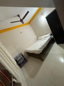 a small bed in a room with a ceiling at Vinayak guest house in Mandrem