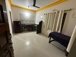 a large white room with a ceiling fan and a room with at Vinayak guest house in Mandrem