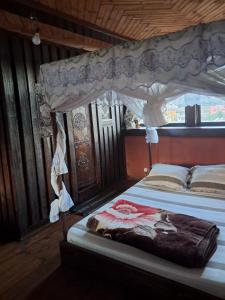a bedroom with a bed with a canopy at Hotel Anjara in Ambositra