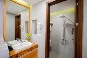 a bathroom with a sink and a shower at Amelia Sầm Sơn Boutique Holtel in Sầm Sơn +16 photos