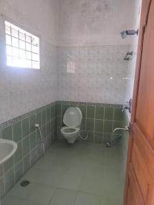 a bathroom with a toilet and a sink at Serenity Villa in Mysore