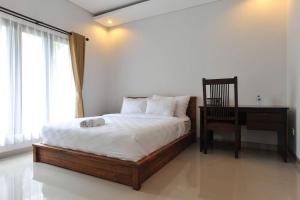 Säng eller sängar i ett rum på UmahOde Bali