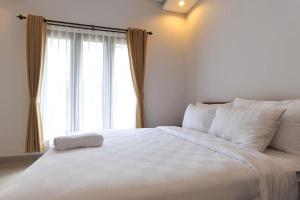 Letto o letti in una camera di UmahOde Bali