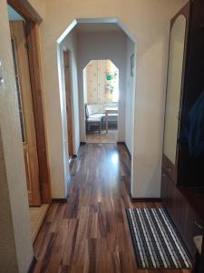 a hallway with a mirror and a living room at MERE Apartment in Sillamäe +7 photos