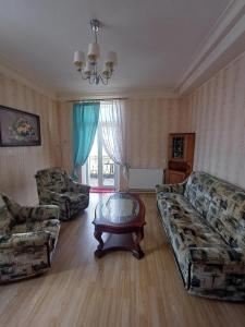 a living room with two couches and a coffee table at MERE Apartment in Sillamäe