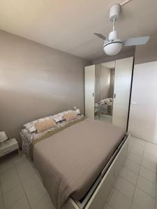 a bedroom with a bed and a ceiling fan at La casa di Giorè - Fronte Mare Gabbiani Ombrellone e 2 lettini inclusi in Fano