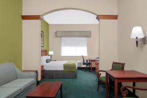 a hotel room with a bed and a couch at Best Western Plus Miami-Doral/Dolphin Mall in Miami