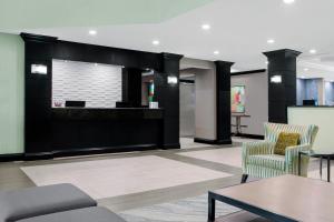 a lobby with two chairs and a table at Best Western Plus Miami-Doral/Dolphin Mall in Miami