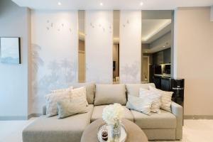 a living room with a couch and a table at Amalea at Benson Pakuwon Mall in Surabaya