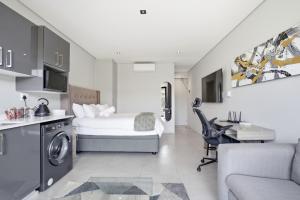 a bedroom with a bed and a desk in a room at Vista Zimbali in Ballito +5 photos