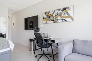 a bedroom with a desk and a chair and a bed at Vista Zimbali in Ballito
