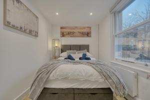 a bedroom with a bed and a window at The Cozy Quarter in Bromley